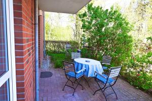 a table and chairs sitting on a patio at Atelier Gartenflair in Hohwacht