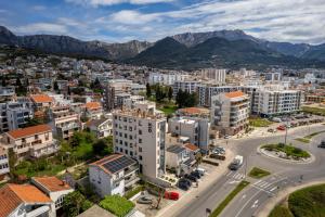 an aerial view of a city with buildings and mountains at XIO Apartments in Bar