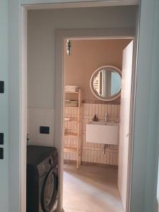 a bathroom with a washing machine and a sink at Cavallerizza flat in Brescia