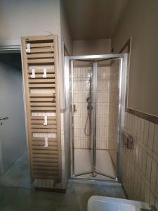 a bathroom with a shower with a glass door at Cavallerizza flat in Brescia