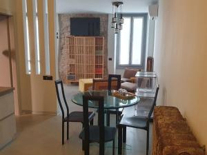 a dining room and living room with a table and chairs at Cavallerizza flat in Brescia