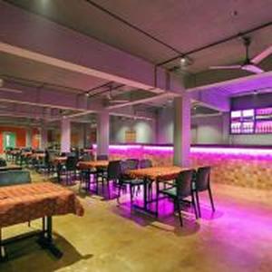 a room with tables and chairs and purple lights at Park Residency Kodungallur in Trichūr