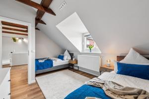 a attic bedroom with two beds and a window at Luxury city apartment with parking in Kiel