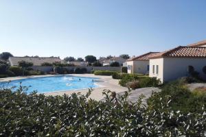 a large swimming pool with people in the water at maison vue sur mer dans les dunes avec acces direct aux plages in Bretignolles-sur-Mer
