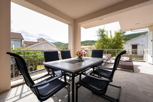 a patio with a table and chairs on a balcony at Simphony Apartments in Tivat