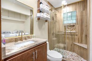 a bathroom with a toilet and a sink and a shower at Pecan Creek Cottage in Fourth Crossing +35 photos