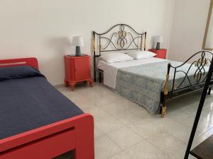 Postel nebo postele na pokoji v ubytování Villetta Clara al mare nel Salento