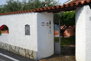 a white building with a gate and a door at Azienda Agrituristica Villa Arianna in Imperia