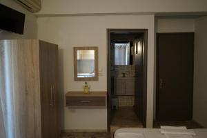 a bathroom with a toilet and a sink and a mirror at ROMANTZA apartments in Agia Marina Nea Kydonias +67 photos