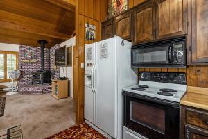 a kitchen with a white refrigerator and a microwave at Pet Friendly The Hideout Yosemite Home in Groveland
