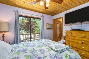 a bedroom with a bed and a large window at Pet Friendly The Hideout Yosemite Home in Groveland