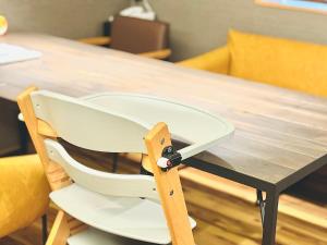 a white chair sitting at a wooden table at Higashiyama bau in Kanazawa