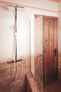 a shower with a glass door in a bathroom at Casa Thula - Hello Vejer in Vejer de la Frontera