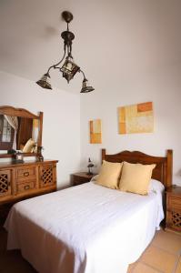 a bedroom with a white bed and a mirror at Casa Thula - Hello Vejer in Vejer de la Frontera