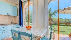 a kitchen with a table with a bowl of oranges on it at Appartamenti dolores castle in Marina di Campo Airport