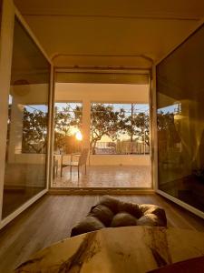 a living room with a large window and a couch at Aegina seaview home in Aegina Town