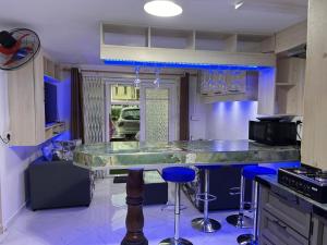 a kitchen with a counter with stools in it at Ashvina Lodge in Flic-en-Flac