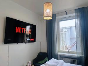 a hotel room with a tv and a window at Nextdoor Host Eco-lodge 24h Self Check-in with Bathtub in Helsinki