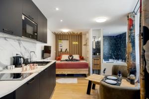 a kitchen and a bedroom with a bed at Love Room - Luxe et Romance in Bourg-en-Bresse