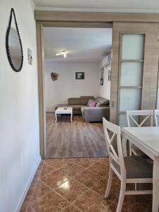 a living room with a couch and a table at Apartman Mano in Topla