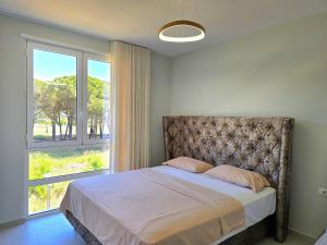 a bedroom with a bed with a large window at San Pietro Holiday Apartment - 288 in Durrës +31 photos