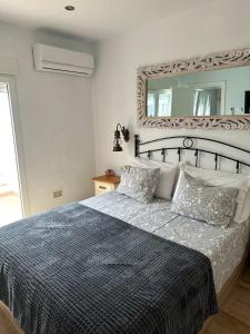 a bedroom with a bed with a large mirror at CASA NOAH in Nerja +18 photos