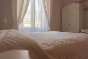 Postel nebo postele na pokoji v ubytování Hotel Maderno