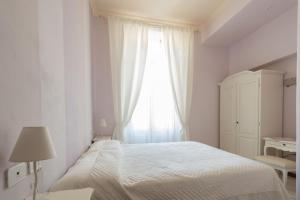Postel nebo postele na pokoji v ubytování Hotel Maderno