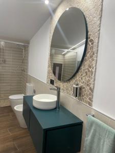 a bathroom with a sink and a mirror at SEVIHOUSE Casa Vicente in Hospital de Órbigo +16 photos