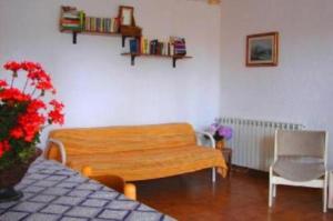 a living room with a bench and a chair at La Terrazza in Barano d'Ischia