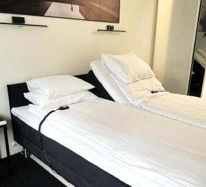 two twin beds in a room with a mirror at Smart 82 in Tartu +23 photos