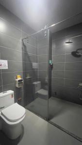a bathroom with a toilet and a glass shower at Start House COLIVING Walk 5 minute to the airport in Ho Chi Minh City +26 photos