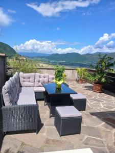 a patio with a couch and chairs and a table at Haus Evi in Termeno
