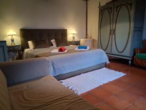 a bedroom with a bed with two towels on it at Casa do Alto (ground floor apartment) in Adaúfe +67 photos