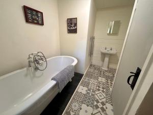a white bathroom with a tub and a sink at Panoramic Mountain Retreat - Waen Fechan - 4x4 access only in Dolgellau
