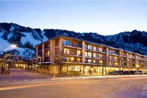 a large building with cars parked in a parking lot at Gold-Rated 2 Bedroom Condo At The Base Of Aspen Mountain in Aspen