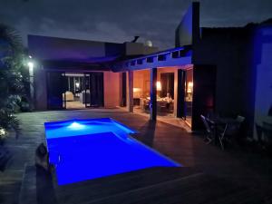 a house with a swimming pool at night at 69 Lagoon House in Marina Beach