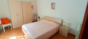 a bedroom with a bed and a cabinet and a chair at La Terrazza in Barano d'Ischia