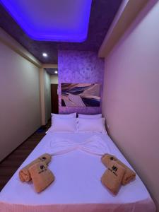 a bedroom with a bed with two towels on it at Hotel Besa in Shëngjin +48 photos
