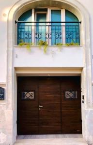 a garage door in a building with a balcony at Casa Vacanze Raimonda in Nardò