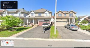 a boat is attached to a pole in front of a house at Fosterbrook Parkside Retreat in Ottawa