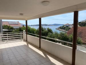 a balcony with a view of the water at Apartment Franjica in Zaglavice