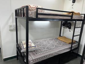 a couple of bunk beds in a room at SIYA Homestay in Kolhapur