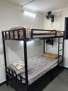 a couple of bunk beds in a room at SIYA Homestay in Kolhapur +6 photos