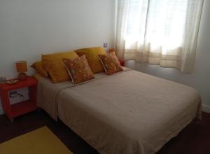 a bedroom with a large bed with a window at T3 Zen in Ciboure