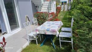 a table and two chairs sitting on a patio at Perla Beach Apartments in Ofrínion