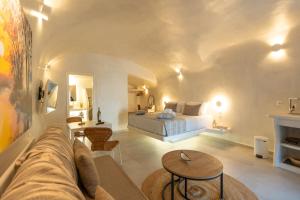 a living room with a bed and a couch at Rody Caves in Oia