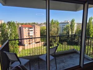 a balcony with two chairs and a view of a building at Le Bellevue in La Roche-sur-Yon