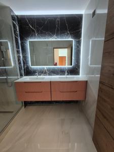 a bathroom with a sink and a mirror at Le Bellevue in La Roche-sur-Yon +7 photos