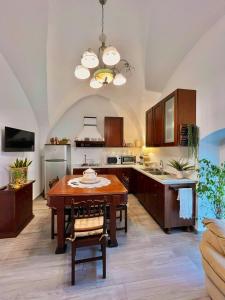 a kitchen with a wooden table and a dining room at Casa Vacanze Raimonda in Nardò